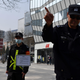 A cop tries to prevent photos from being taken outside an H&M store in Beijing on March 25, 2021.